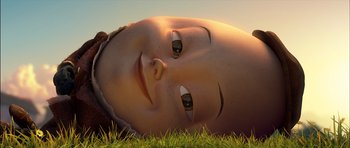 Movie still from “Puss in Boots” (2011), directed by Chris Miller – An image of a child laying in the grass; Extreme Close Up shot, Low angle