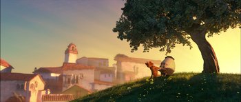 Movie still from “Puss in Boots” (2011), directed by Chris Miller – An animated dog sitting on top of a grassy hill next to a tree; Extreme Wide shot, Low angle