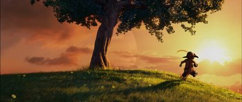 Movie still from “Puss in Boots” (2011), directed by Chris Miller – An image of a tree on a grassy hill at sunset; Extreme Wide shot, Low angle