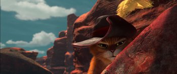 Movie still from “Puss in Boots” (2011), directed by Chris Miller – An orange cat wearing a cowboy hat in a rocky area; Close Up shot, Low angle