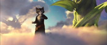 Movie still from “Puss in Boots” (2011), directed by Chris Miller – An animated cat standing in the middle of a cloud filled sky next to a plant; Medium shot, Low angle