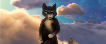 Movie still from “Puss in Boots” (2011), directed by Chris Miller – A cat is standing in front of a sky background; Close Up shot, Low angle