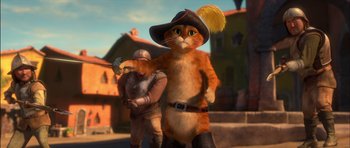 Movie still from “Puss in Boots” (2011), directed by Chris Miller – An orange cat wearing a pirate's hat standing next to a man; Medium shot, Low angle