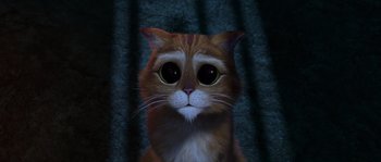 Movie still from “Puss in Boots” (2011), directed by Chris Miller – An orange and white cat with big green eyes; Close Up shot, High angle