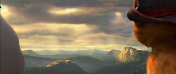 Movie still from “Puss in Boots” (2011), directed by Chris Miller – A view of a mountain range with a cloudy sky above it; Extreme Wide shot, Low angle