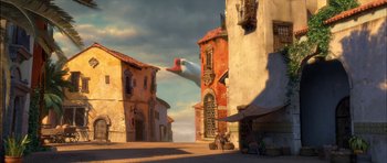 Movie still from “Puss in Boots” (2011), directed by Chris Miller – An airplane is flying over an old building; Extreme Wide shot, Low angle