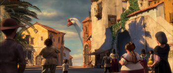 Movie still from “Puss in Boots” (2011), directed by Chris Miller – An image of an animated scene with a giant bird in the middle of the street; Extreme Wide shot, Low angle