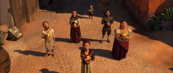 Movie still from “Puss in Boots” (2011), directed by Chris Miller – A group of people standing around each other holding apples; Wide shot, High angle