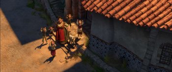 Movie still from “Puss in Boots” (2011), directed by Chris Miller – An overhead view of a group of people standing on the side of a house; Wide shot, High angle