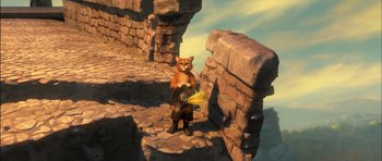 Movie still from “Puss in Boots” (2011), directed by Chris Miller – An animated cat standing next to a stone wall; Wide shot, High angle