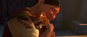 Movie still from “Puss in Boots” (2011), directed by Chris Miller – A person holding a cat in their arms and smiling; Close Up shot, Over the shoulder angle