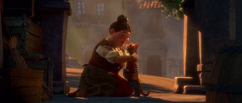 Movie still from “Puss in Boots” (2011), directed by Chris Miller – An animated woman holding a cat in her hands; Wide shot, Over the shoulder angle