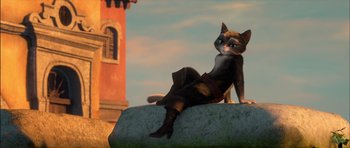 Movie still from “Puss in Boots” (2011), directed by Chris Miller – A cat sitting on top of a rock with a lighthouse in the background; Medium shot, Low angle
