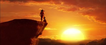 Movie still from “Puss in Boots” (2011), directed by Chris Miller – A man standing on top of a cliff at the top of a mountain; Wide shot, Low angle