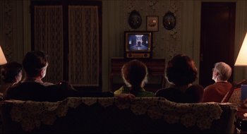 Movie still from “Quiz Show” (1994), directed by Robert Redford – A group of people sitting in front of a television; Wide shot, High angle