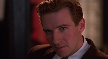 Movie still from “Quiz Show” (1994), directed by Robert Redford – A person wearing a suit and tie; Close Up shot, Over the shoulder angle