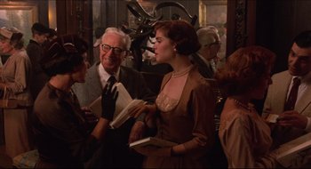 Movie still from “Quiz Show” (1994), directed by Robert Redford – A man and a woman are talking to each other in a room; Medium shot, Over the shoulder angle