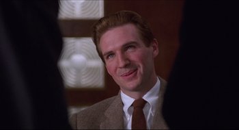 Movie still from “Quiz Show” (1994), directed by Robert Redford – A person wearing a suit and tie; Close Up shot, Over the shoulder angle