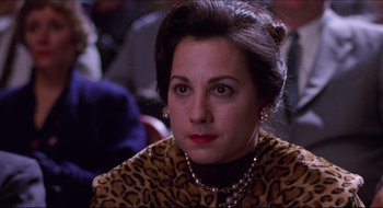 Movie still from “Quiz Show” (1994), directed by Robert Redford – A person wearing a leopard print jacket; Close Up shot, Over the shoulder angle