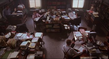 Movie still from “Quiz Show” (1994), directed by Robert Redford – A group of people sitting at a table in a room; Wide shot, High angle