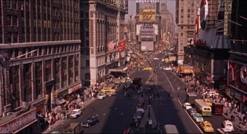 Movie still from “Quiz Show” (1994), directed by Robert Redford – A busy city street filled with lots of traffic; Extreme Wide shot, High angle