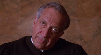 Movie still from “Quiz Show” (1994), directed by Robert Redford – An older man in a judge's robe looking at the camera; Close Up shot, Low angle