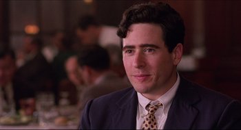 Movie still from “Quiz Show” (1994), directed by Robert Redford – A person wearing a suit and a tie; Close Up shot, Over the shoulder angle