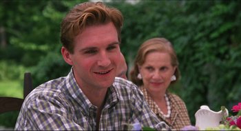 Movie still from “Quiz Show” (1994), directed by Robert Redford – A man and a woman smiling for the camera; Close Up shot, Over the shoulder angle