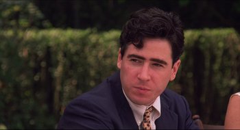 Movie still from “Quiz Show” (1994), directed by Robert Redford – A person wearing a suit and tie; Close Up shot, Over the shoulder angle