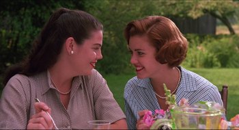 Movie still from “Quiz Show” (1994), directed by Robert Redford – Two women sitting at a table talking to each other; Close Up shot, Low angle