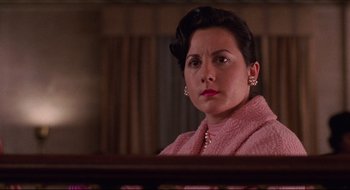 Movie still from “Quiz Show” (1994), directed by Robert Redford – A woman wearing a pink sweater and a pink scarf; Close Up shot, Low angle