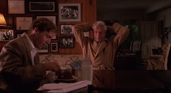 Movie still from “Quiz Show” (1994), directed by Robert Redford – An older man and a young boy in a room; Medium shot, Over the shoulder angle