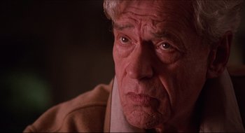 Movie still from “Quiz Show” (1994), directed by Robert Redford – An older man with a concerned look on his face; Close Up shot, Over the shoulder angle