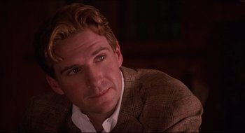 Movie still from “Quiz Show” (1994), directed by Robert Redford – A person wearing a suit and tie; Close Up shot, Over the shoulder angle