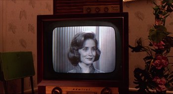 Movie still from “Quiz Show” (1994), directed by Robert Redford – An old television with a woman on the screen; Close Up shot, Over the shoulder angle