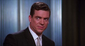 Movie still from “Quiz Show” (1994), directed by Robert Redford – A person wearing a suit and tie; Close Up shot, Low angle