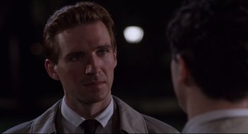 Movie still from “Quiz Show” (1994), directed by Robert Redford – A man wearing a suit and tie talking to another man wearing a suit and tie; Close Up shot, Over the shoulder angle