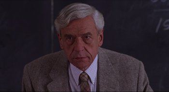 Movie still from “Quiz Show” (1994), directed by Robert Redford – An older man wearing a suit and a tie; Close Up shot, Over the shoulder angle