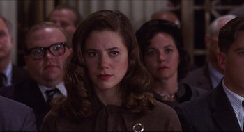 Movie still from “Quiz Show” (1994), directed by Robert Redford – A group of people sitting in a room; Close Up shot, Over the shoulder angle