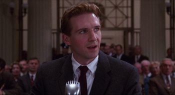 Movie still from “Quiz Show” (1994), directed by Robert Redford – A person wearing a suit and tie; Close Up shot, Low angle