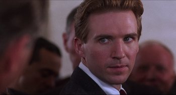 Movie still from “Quiz Show” (1994), directed by Robert Redford – A person wearing a suit and tie; Close Up shot, Over the shoulder angle