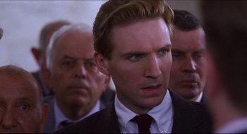 Movie still from “Quiz Show” (1994), directed by Robert Redford – A person wearing a suit and tie; Close Up shot, Over the shoulder angle