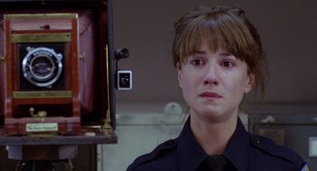 Movie still from “Raising Arizona” (1987), directed by Joel Coen – A police officer is looking at the camera; Close Up shot, Over the shoulder angle
