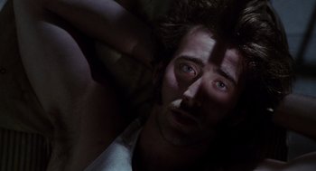 Movie still from “Raising Arizona” (1987), directed by Joel Coen – A person laying on the ground; Close Up shot, Overhead angle