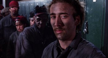 Movie still from “Raising Arizona” (1987), directed by Joel Coen – A man in a striped shirt and a man in a black hat; Close Up shot, Low angle