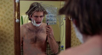 Movie still from “Raising Arizona” (1987), directed by Joel Coen – A man shaving his face in the mirror; Close Up shot, Low angle