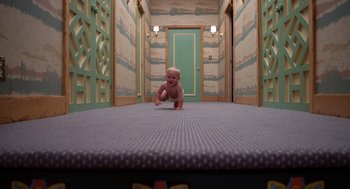 Movie still from “Raising Arizona” (1987), directed by Joel Coen – A baby crawling on the floor in a room; Wide shot, Overhead angle