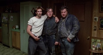 Movie still from “Raising Arizona” (1987), directed by Joel Coen – A group of men standing next to each other in a room; Medium shot, Low angle