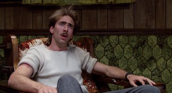 Movie still from “Raising Arizona” (1987), directed by Joel Coen – A man sitting in a chair with his mouth wide open; Close Up shot, Low angle