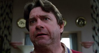 Movie still from “Raising Arizona” (1987), directed by Joel Coen – A person with his mouth wide open; Close Up shot, Low angle